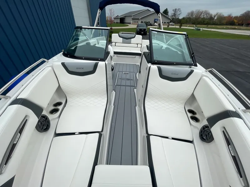 Slide: The Image of 2024 Chaparral 247 SSX boat interior with white and gray seating. - 16