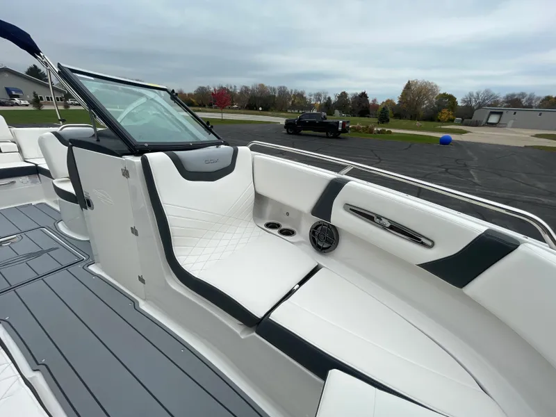 Slide: The Image of 2024 Chaparral 247 SSX boat interior with white and black seating. - 17