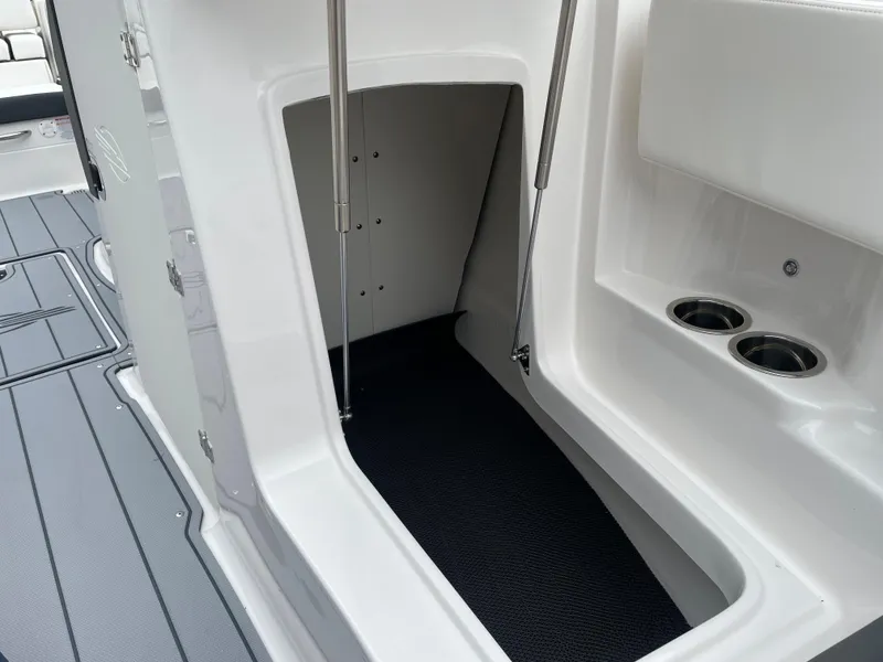 Slide: The Image of 2024 Chaparral 247 SSX boat interior storage compartment with cup holders. - 18
