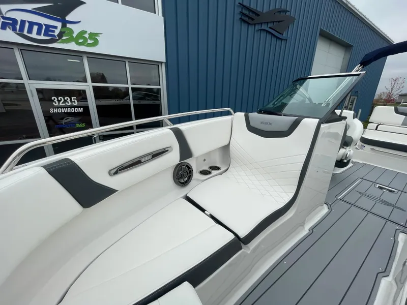 Slide: The Image of 2024 Chaparral 247 SSX boat interior with white and gray seating. - 19