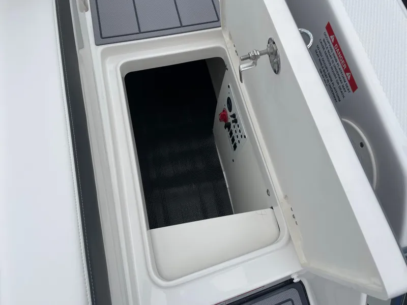 Slide: The Image of Open storage compartment on a 2024 Chaparral 247 SSX boat. - 27