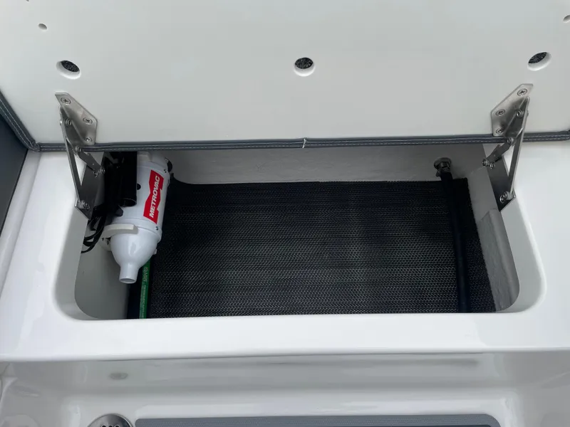 Slide: The Image of Storage compartment of 2024 Chaparral 247 SSX boat with fire extinguisher. - 28