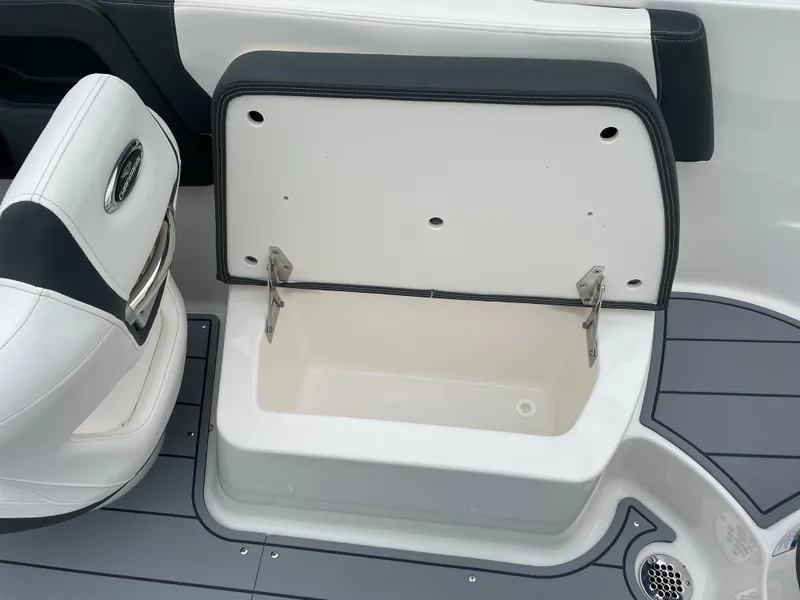 Slide: The Image of 2024 Chaparral 247 SSX boat storage compartment with open lid. - 30
