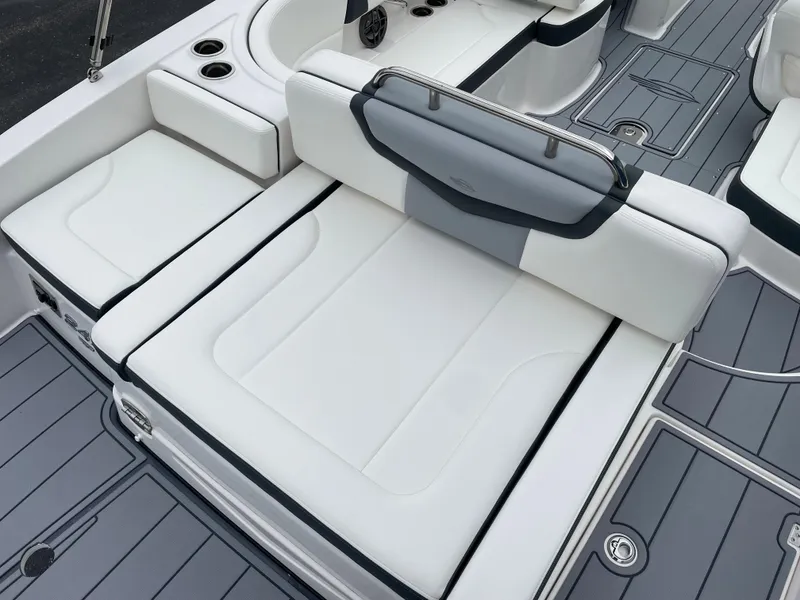Slide: The Image of 2024 Chaparral 247 SSX boat interior with white cushioned seating and gray flooring. - 32