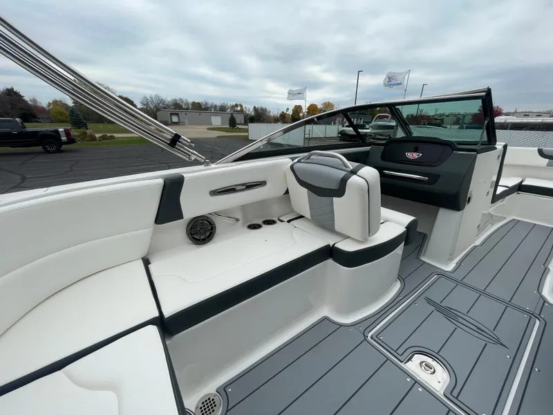 Slide: The Image of 2024 Chaparral 247 SSX boat interior with white and gray seating. - 39