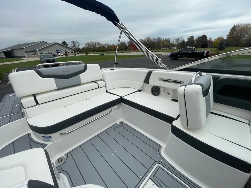 Slide: The Image of 2024 Chaparral 247 SSX boat interior with white and gray seating. - 41