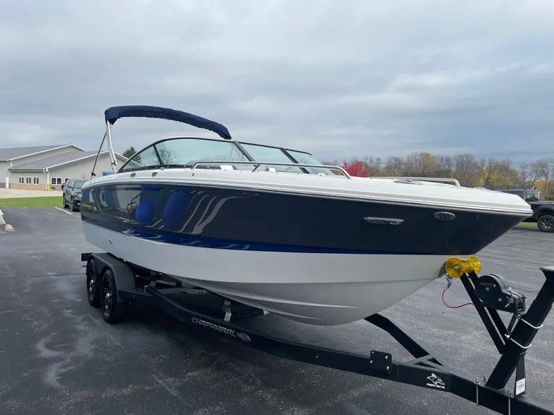 Slide: The Image of 2024 Chaparral 247 SSX boat on trailer, parked outdoors. - 6