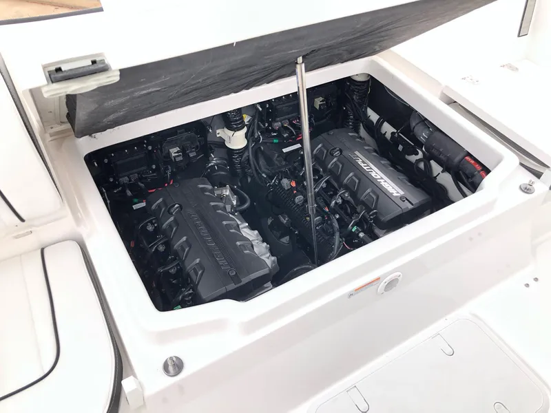 Slide: The Image of 2023 Yamaha Boats 222 FSH Sport E engine compartment with dual engines. - 12