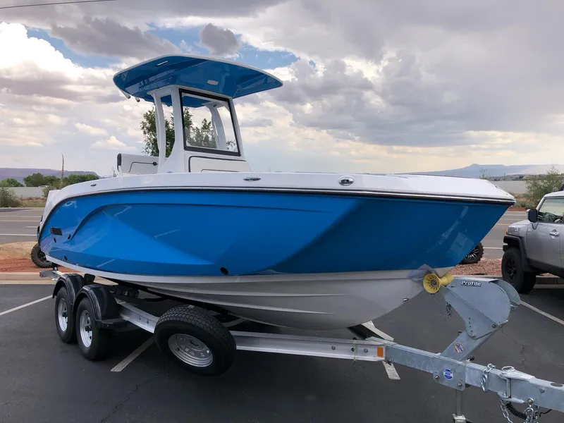 Slide: The Image of 2023 Yamaha Boats 222 FSH Sport E in blue on a trailer. - 2