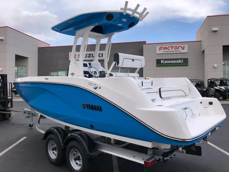 Slide: The Image of 2023 Yamaha Boats 222 FSH Sport E in blue, displayed at a dealership. - 4