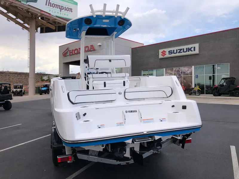 Slide: The Image of 2023 Yamaha Boats 222 FSH Sport E displayed at a dealership. - 5