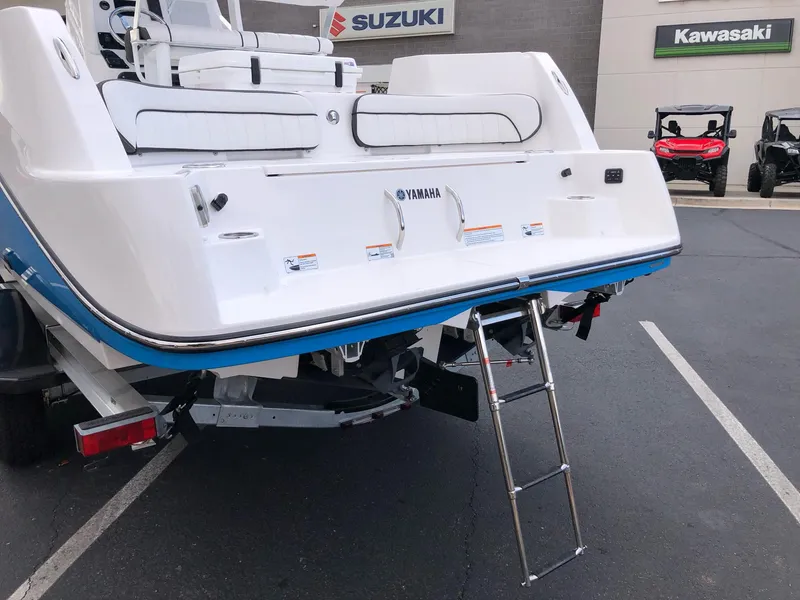 Slide: The Image of 2023 Yamaha Boats 222 FSH Sport E rear view with swim platform and ladder. - 7