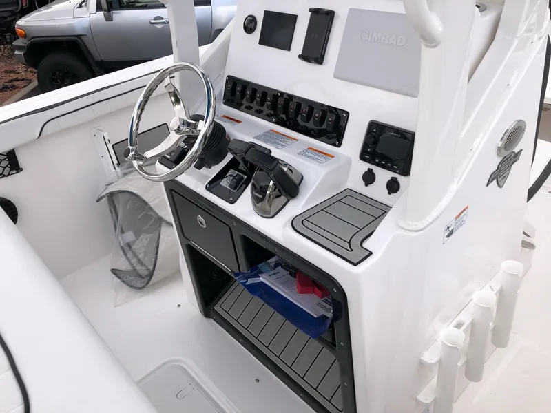 Slide: The Image of 2023 Yamaha Boats 222 FSH Sport E console with steering wheel and control panel. - 8