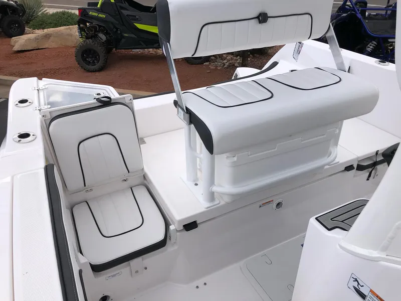 Slide: The Image of 2023 Yamaha Boats 222 FSH Sport E interior seating with white and black upholstery. - 9
