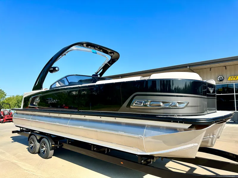 Slide: The Image of 2023 Tahoe Pontoon 27FT Grand Tahoe LTD Elite on trailer, sleek black design. - 2
