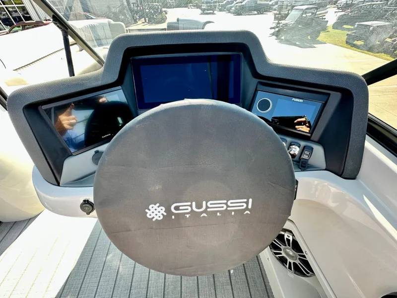 Slide: The Image of 2023 Tahoe Pontoon 27FT Grand Tahoe LTD Elite dashboard with Gussi Italia steering wheel. - 8
