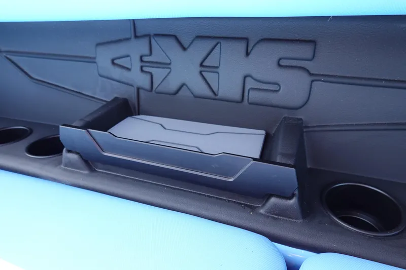 Slide: The Image of 2024 Axis A225 boat interior detail with cup holders and storage compartment. - 17