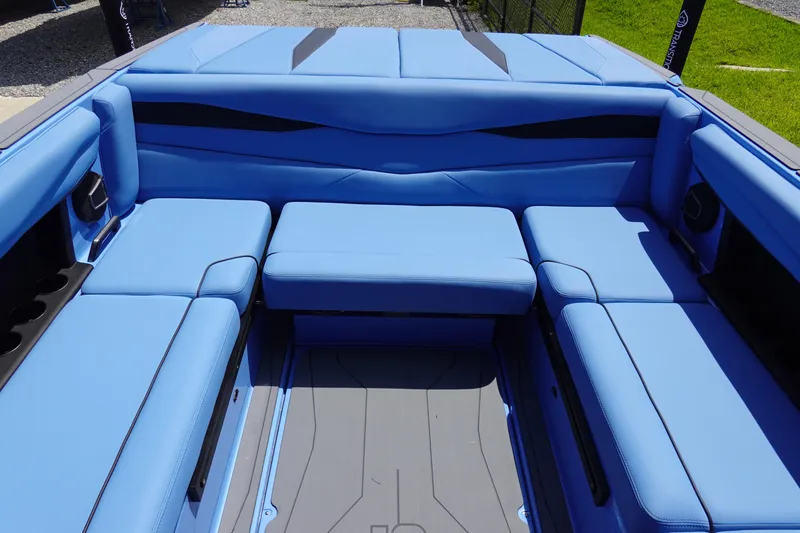 Slide: The Image of 2024 Axis A225 boat interior with blue cushioned seating. - 18