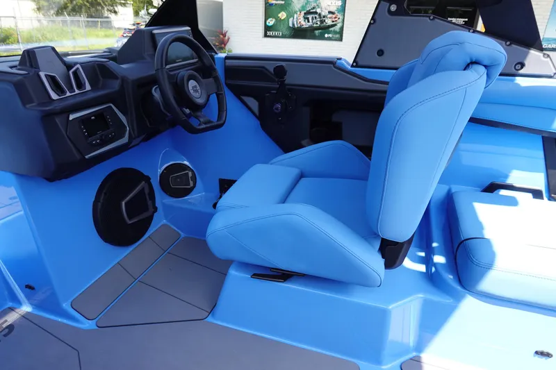 Slide: The Image of 2024 Axis A225 boat interior with blue seating and modern dashboard. - 23