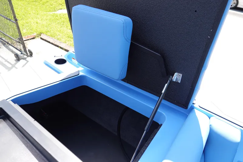 Slide: The Image of 2024 Axis A225 boat storage compartment with blue upholstery and hydraulic lift. - 26