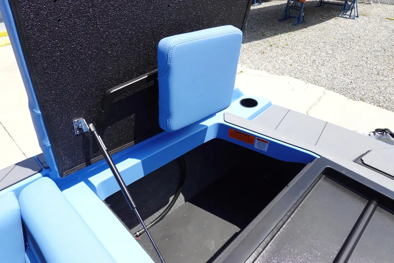 Slide: The Image of 2024 Axis A225 boat storage compartment with blue upholstery and hydraulic lift. - 27