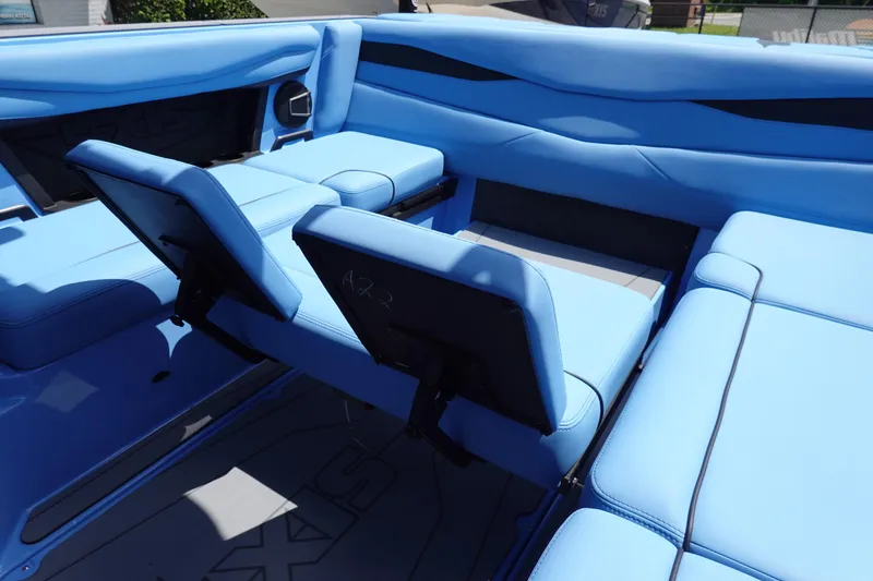 Slide: The Image of 2024 Axis A225 boat interior with blue seating and adjustable backrests. - 30