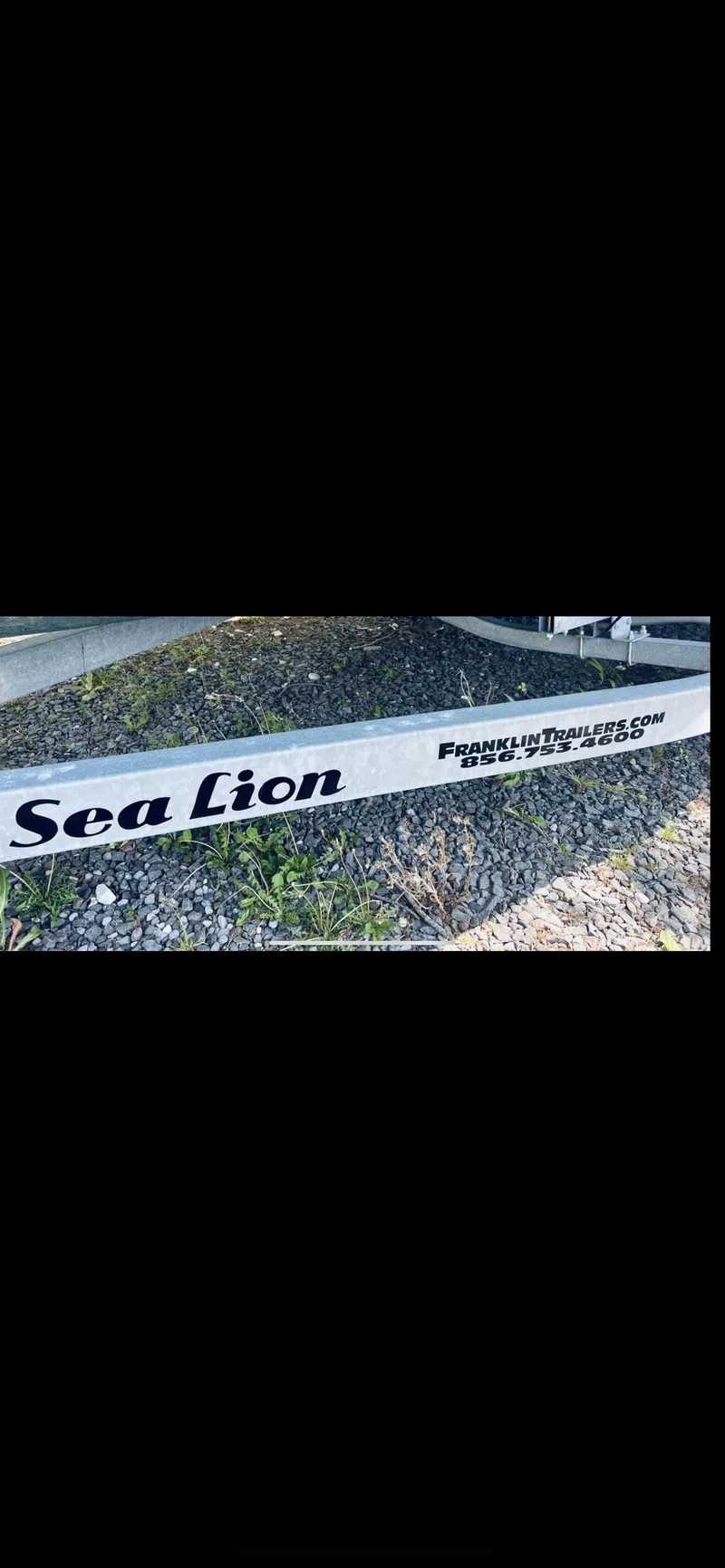 Slide: The Image of 1988 Grady-White Offshore boat trailer with Sea Lion branding. - 12