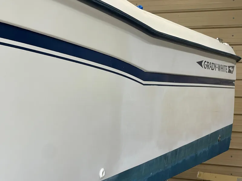 Slide: The Image of 1988 Grady-White Offshore boat side view with blue stripe. - 8