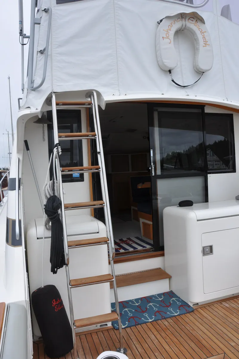 Slide: The Image of 1987 Bertram 37 Convertible yacht with ladder and open cabin door. - 10