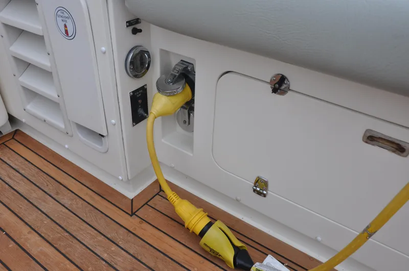 Slide: The Image of 1987 Bertram 37 Convertible boat with yellow shore power cable on deck. - 11