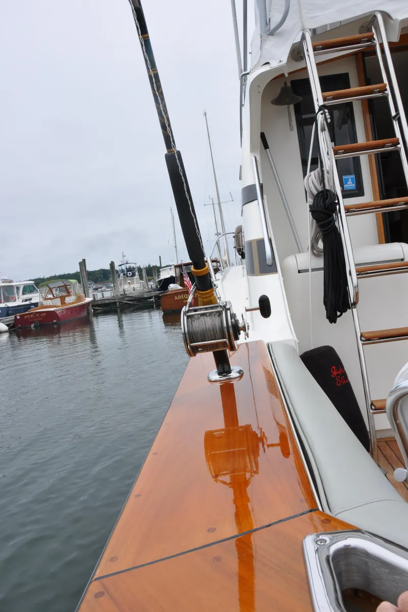 Slide: The Image of 1987 Bertram 37 Convertible yacht docked at a marina. - 14