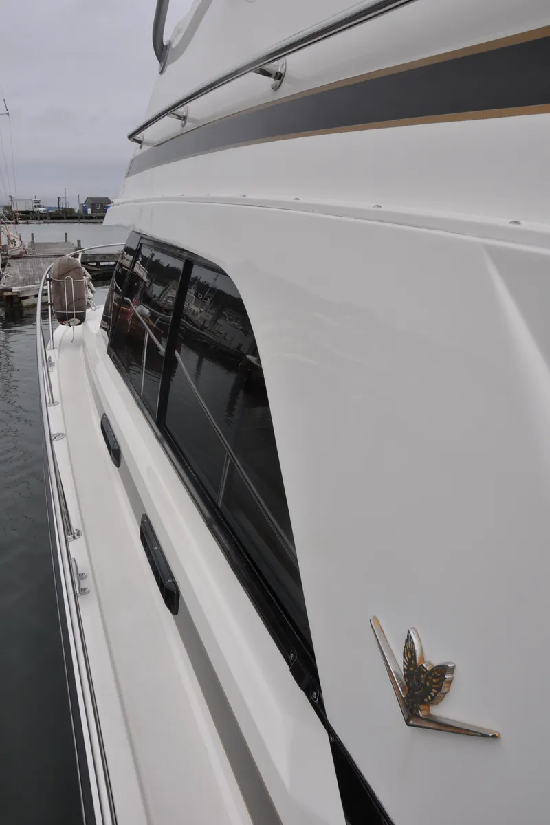 Slide: The Image of 1987 Bertram 37 Convertible yacht docked at a marina. - 15