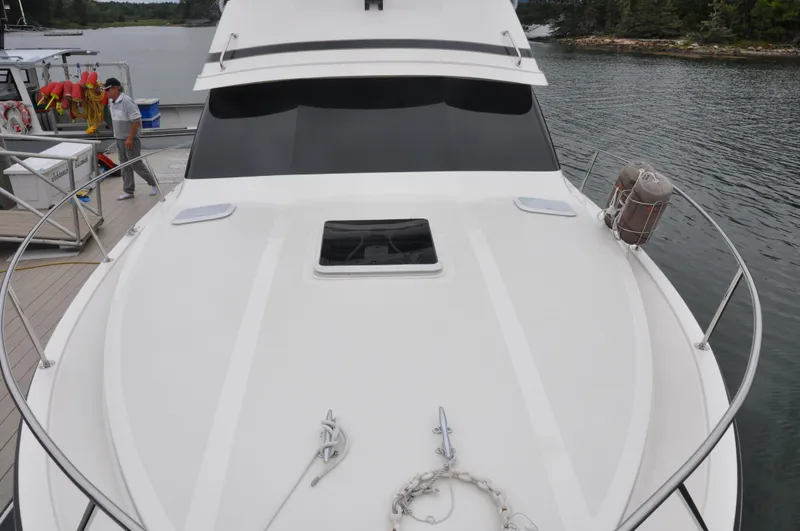 Slide: The Image of 1987 Bertram 37 Convertible yacht docked at a marina. - 18