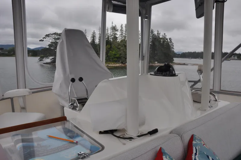 Slide: The Image of 1987 Bertram 37 Convertible boat interior with helm station and scenic water view. - 21