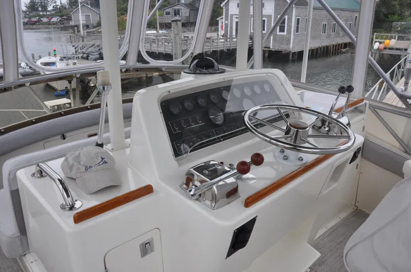 Slide: The Image of 1987 Bertram 37 Convertible boat helm with steering wheel and control panel. - 24