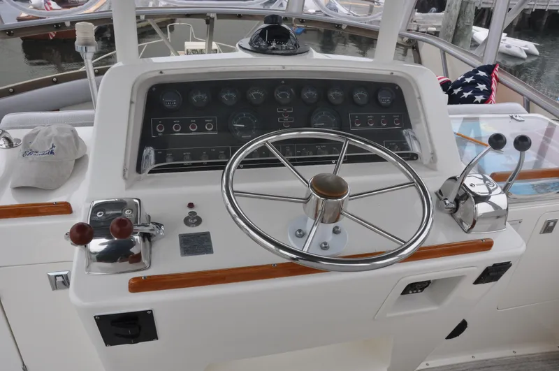 Slide: The Image of 1987 Bertram 37 Convertible boat helm with steering wheel and control panel. - 26