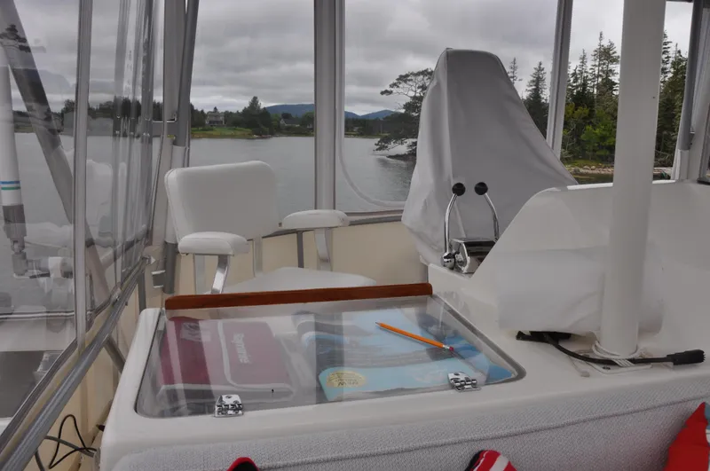 Slide: The Image of 1987 Bertram 37 Convertible boat interior with helm station and navigational equipment. - 27