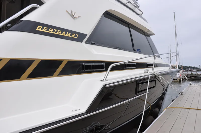 Slide: The Image of 1987 Bertram 37 Convertible yacht docked at a marina. - 3