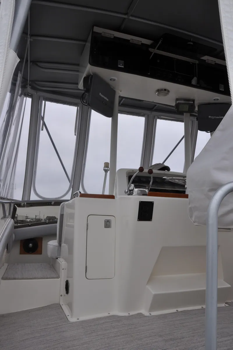 Slide: The Image of 1987 Bertram 37 Convertible boat interior with helm station and controls. - 31