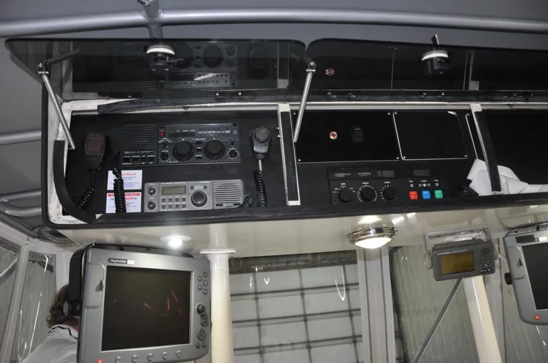 Slide: The Image of 1987 Bertram 37 Convertible boat cockpit with navigation and communication equipment. - 32