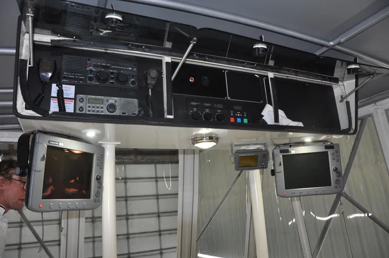 Slide: The Image of 1987 Bertram 37 Convertible boat cockpit with navigation and communication equipment. - 33