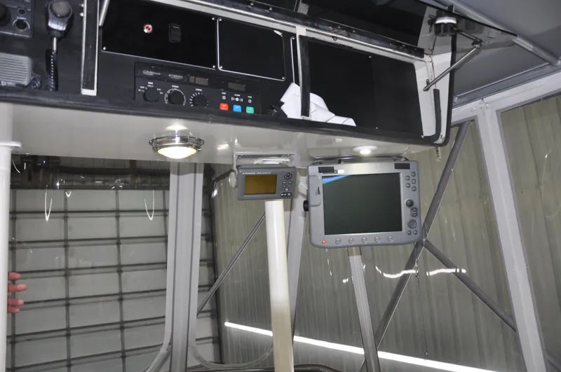 Slide: The Image of 1987 Bertram 37 Convertible boat cockpit with navigation equipment. - 34