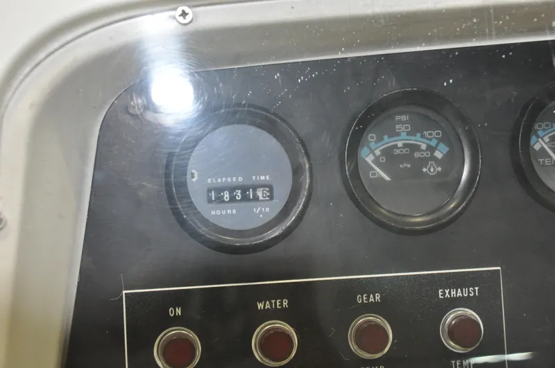Slide: The Image of Close-up of 1987 Bertram 37 Convertible boat dashboard with elapsed time and pressure gauges. - 35