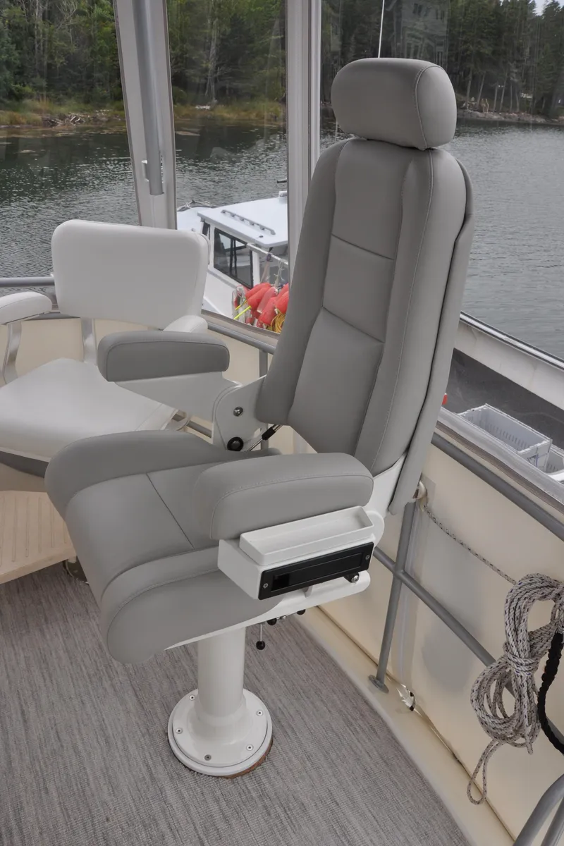 Slide: The Image of Captain's chair on a 1987 Bertram 37 Convertible yacht, overlooking water. - 37