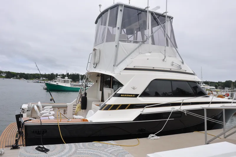Slide: The Image of 1987 Bertram 37 Convertible yacht docked at a marina. - 4