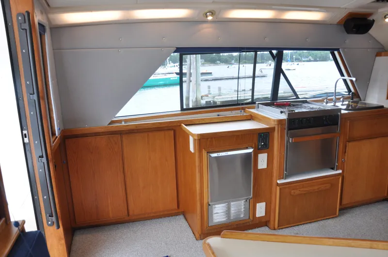 Slide: The Image of Interior of 1987 Bertram 37 Convertible yacht with wooden cabinetry and kitchen appliances. - 41
