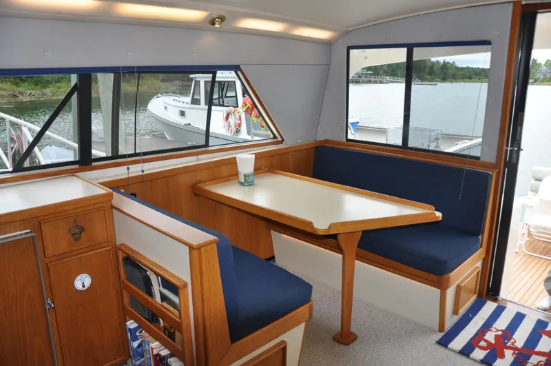 Slide: The Image of Interior of 1987 Bertram 37 Convertible yacht with dining area and waterfront view. - 43
