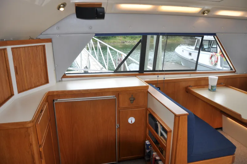 Slide: The Image of Interior of a 1987 Bertram 37 Convertible yacht with wooden cabinetry and seating. - 44