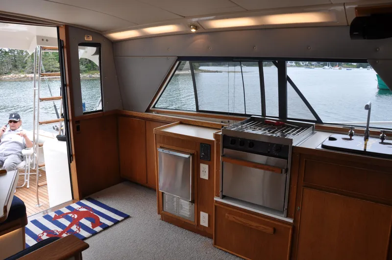 Slide: The Image of Interior of 1987 Bertram 37 Convertible yacht with kitchen and outdoor seating area. - 46