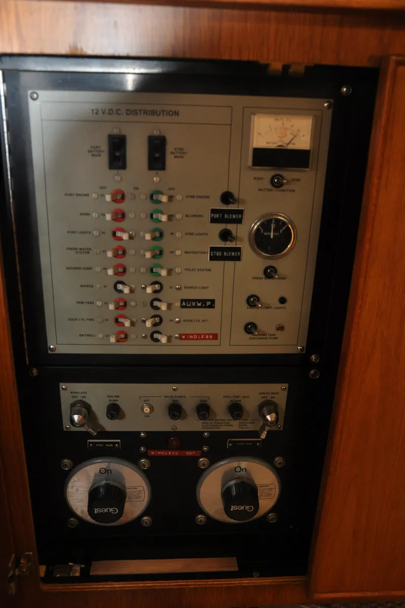 Slide: The Image of 1987 Bertram 37 Convertible electrical control panel with gauges and switches. - 48